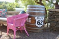 Barrel with the sing Ã¢â¬Å¾Route 62Ã¢â¬Å and pink chair in Barrydale, South Africa. Royalty Free Stock Photo